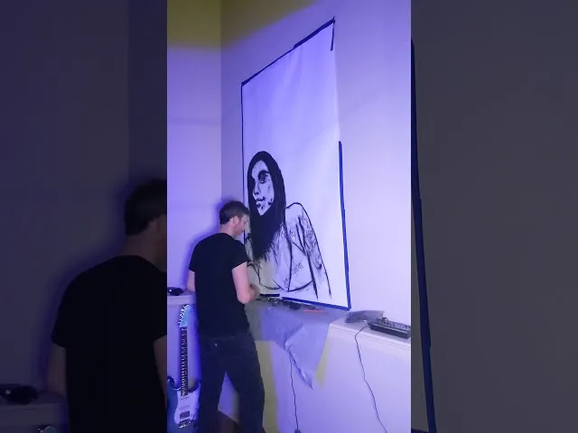 Large charcoal portrait drawing displayed indoors
