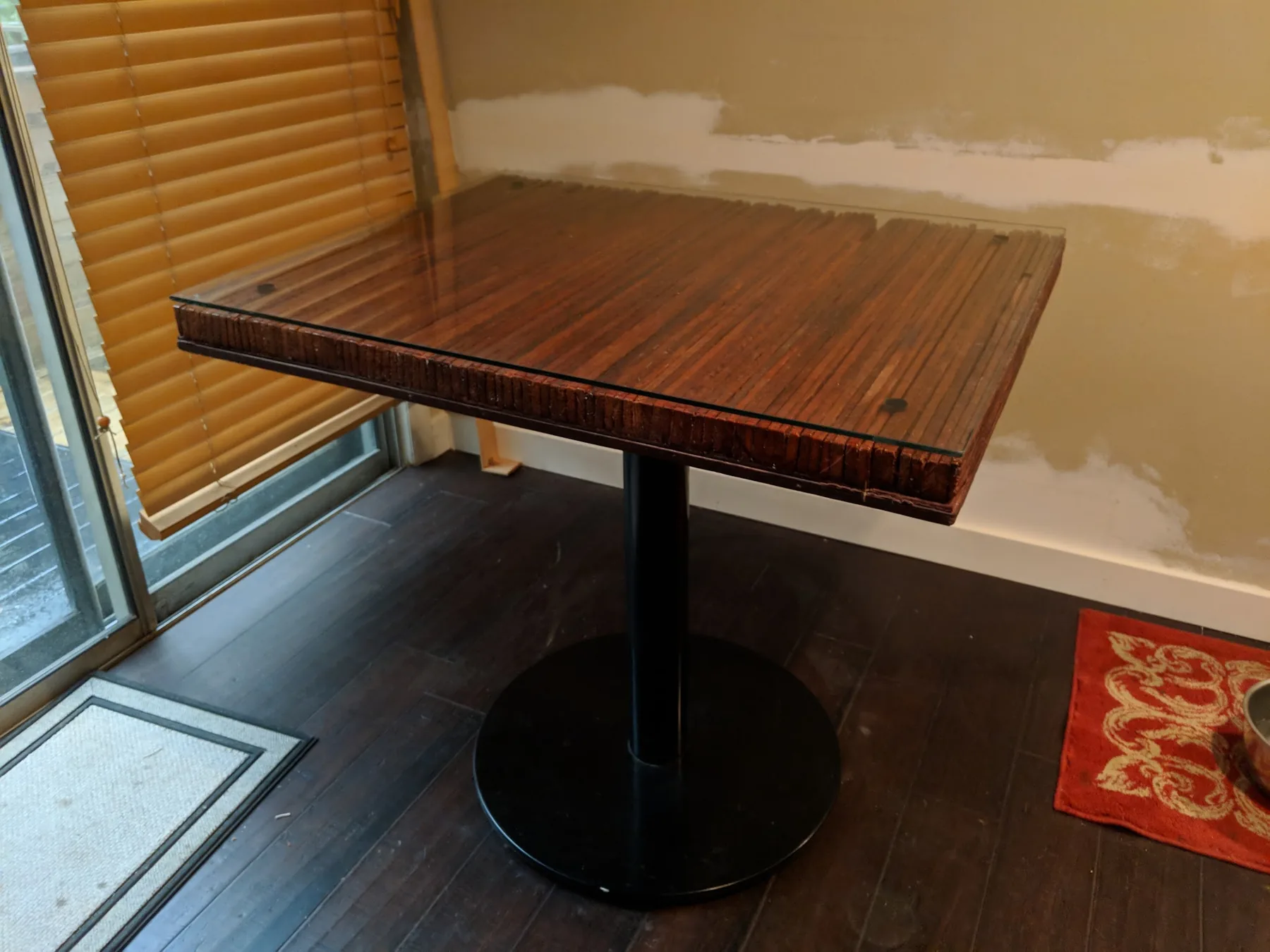 Handmade dark wood table with metal pedestal base